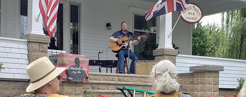 Photo of a performer and several audience members from one of the concerts during the 2021 Porch Music Fest
