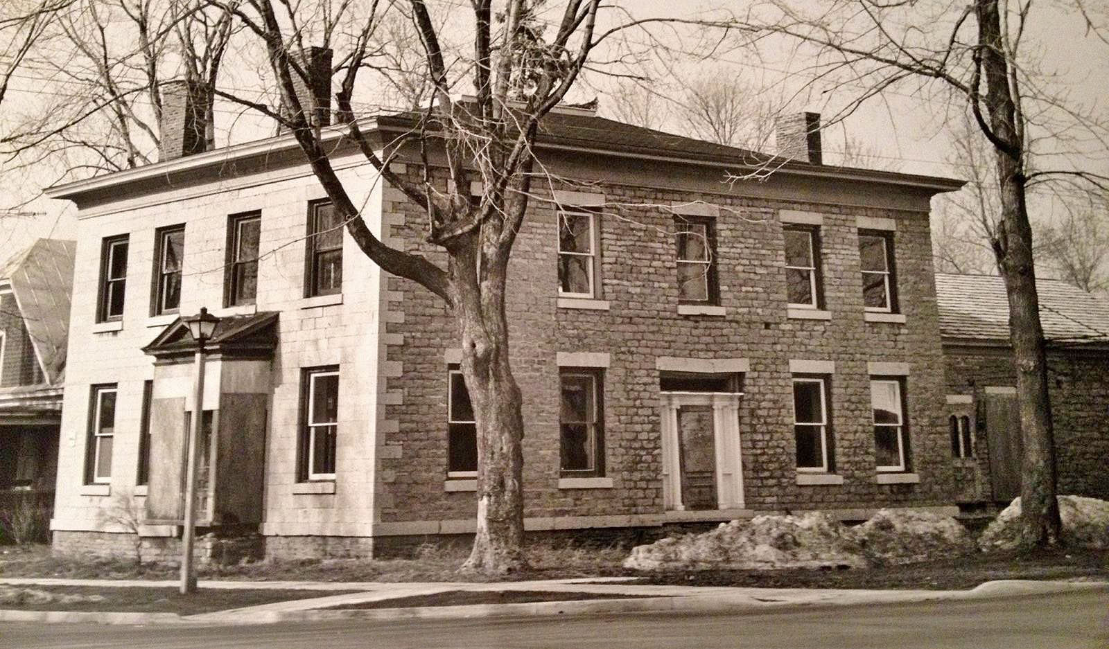 Black and white photo of the Bank Building before the restoration by the Sackets Harbor Historical Society